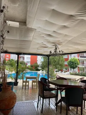 a patio with a table and chairs under a tent at Fort Noks Grand Resort Wave&Dreams in Sveti Vlas