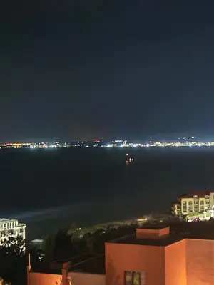 a view of the ocean at night at Fort Noks Grand Resort Wave&Dreams in Sveti Vlas
