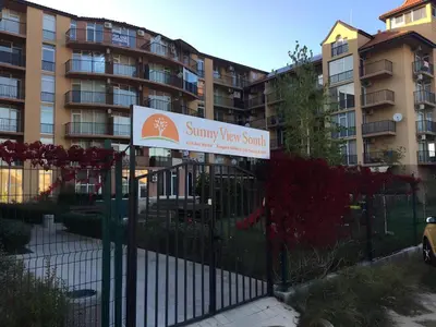 a sign on a fence in front of a building at Студия Авангард in Sunny Beach