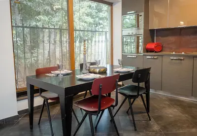 a kitchen with a black table and four chairs at Cozy Flat with Two Bedrooms in Central Varna by Flat Mаnаger in Varna City