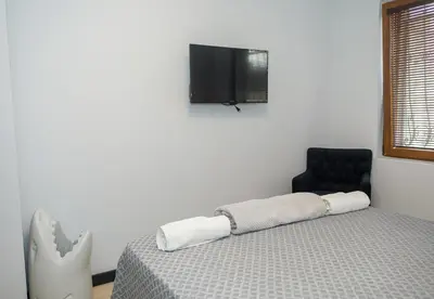 a bedroom with a bed and a tv on the wall at Cozy Flat with Two Bedrooms in Central Varna by Flat Mаnаger in Varna City