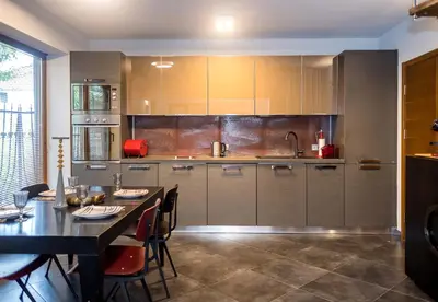 a kitchen with a table and a dining room at Cozy Flat with Two Bedrooms in Central Varna by Flat Mаnаger in Varna City