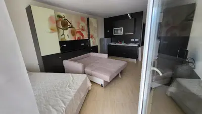 a small room with a bed and a table at Studio F210 - Bulharsko in Aheloy