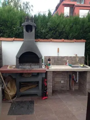 an outdoor pizza oven sitting in a backyard at The White Houses 7 in Nesebar