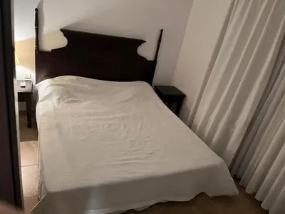 a bedroom with a bed with a white sheet at Eco Apartment Cliff in Obzor