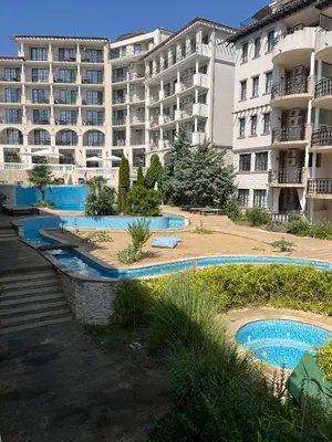 an apartment complex with two pools and a building at Eco Apartment Cliff in Obzor