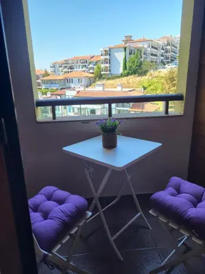 a table and two stools in front of a window at Garden of Eden studio in Sveti Vlas