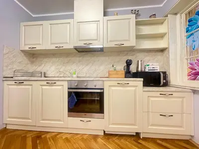 a kitchen with white cabinets and a microwave at 'Golden Bird' Apartment, 2 Bedrooms, Super Central in Burgas City