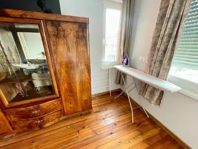 a room with a wooden cabinet and a window at 'Sea South' Apartment, Super Central, Vintage Style, 1BDR in Burgas City