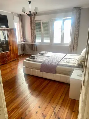 a bedroom with a bed and a wooden floor at 'Sea South' Apartment, Super Central, Vintage Style, 1BDR in Burgas City
