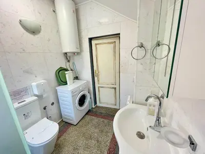 a bathroom with a sink toilet and a washing machine at 'Sea South' Apartment, Super Central, Vintage Style, 1BDR in Burgas City