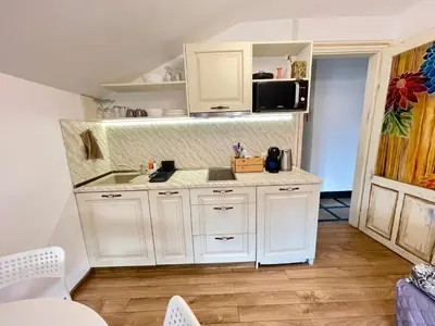 a kitchen with white cabinets and a sink at 'Sea South' Apartment, Super Central, Vintage Style, 1BDR in Burgas City