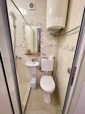 a small bathroom with a toilet and a sink at 'The Conch' Room with Private Entrance and Bathroom in Burgas City