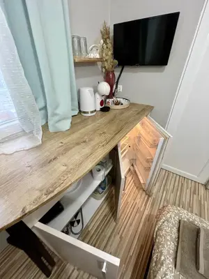 a desk in a room with a television on a wall at 'The Conch' Room with Private Entrance and Bathroom in Burgas City