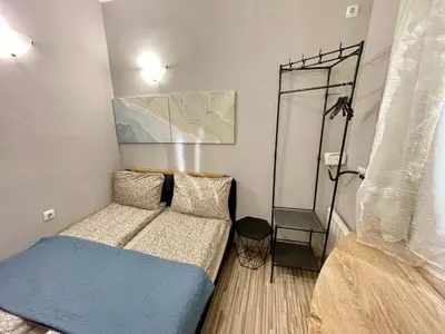 a small bedroom with a bed and a mirror at 'The Conch' Room with Private Entrance and Bathroom in Burgas City