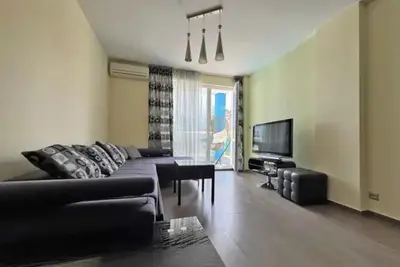 a living room with a couch and a television at Apartments Nessebar in Nesebar