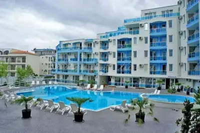 a large apartment building with a large swimming pool at Apartments Nessebar in Nesebar