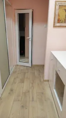 an empty room with a door and a wooden floor at апартамент Климент in Varna City