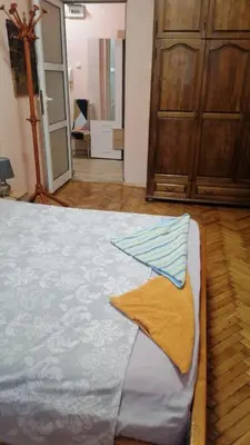 a bedroom with a bed with a towel on it at апартамент Климент in Varna City