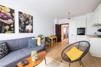 a living room with a couch and a kitchen at Chic Downtown Flat in Varna City