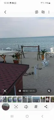 a picture of a beach with a table and chairs at Апартамент Феличита in Byala