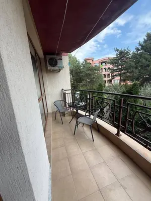 two chairs and a table on a balcony at Pacific 3 Apartments in Sunny Beach