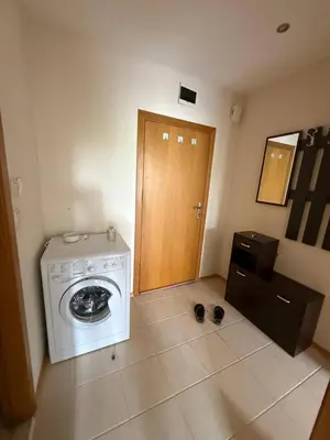 a room with a washing machine and a wooden door at Pacific 3 Apartments in Sunny Beach