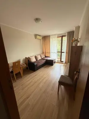 a living room with a couch and a table at Pacific 3 Apartments in Sunny Beach