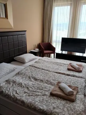 a bedroom with a large bed with towels on it at Studio Royal Beach Barcello in Sunny Beach