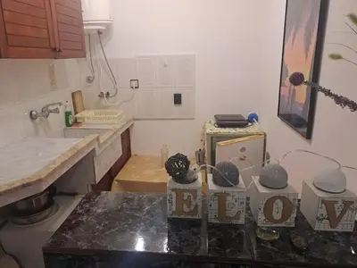a kitchen with a counter and a counter top with a sink at Бюджетна стая за двама in Pomorie