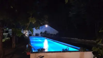 a swimming pool at night with a light above it at Apartment With 2 Bedrooms - Magic Woods