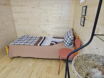a small room with a bed and two chairs at Apartment With 2 Bedrooms - Magic Woods
