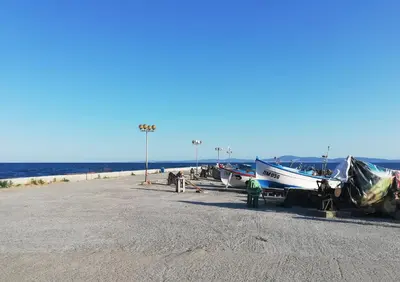 a group of boats are parked on the beach at Sunny Day Apartment in Pomorie