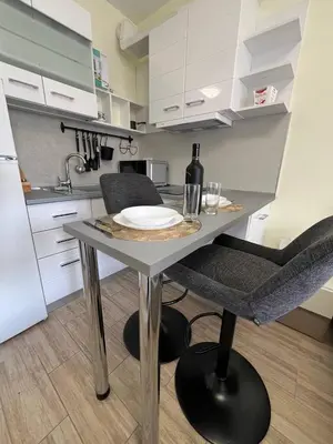 a kitchen with a table with a wine bottle on it at Coastera Group Cascadas 8 in Sunny Beach