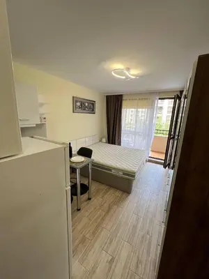 a bedroom with a bed and a table and a window at Coastera Group Cascadas 8 in Sunny Beach