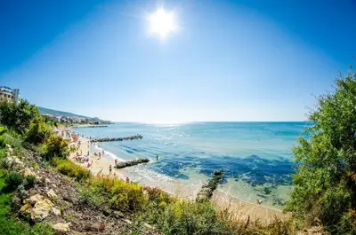 a view of a beach with people in the water at Premier Fort Sands Resort - Full Board in Sunny Beach