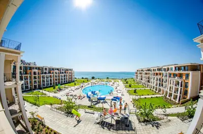 a view of the pool and the ocean from the balcony of a resort at Premier Fort Sands Resort - Full Board in Sunny Beach