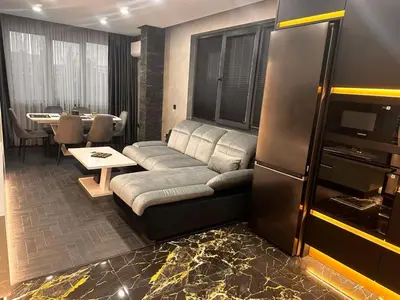 a living room with a couch and a table at Golden Pearl of Luxury - Burgas in Burgas City