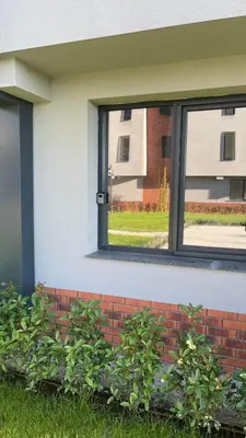 a window on the side of a building with plants at Golden Pearl of Luxury - Burgas in Burgas City