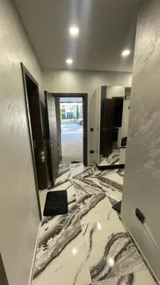 a bathroom with a marble floor and a hallway with mirrors at Golden Pearl of Luxury - Burgas in Burgas City