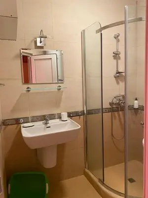 a bathroom with a sink and a shower with a mirror at Sunny Home 2 in Sunny Beach