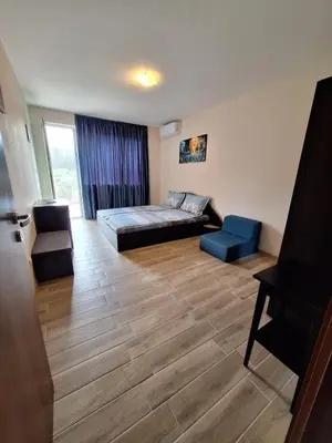 a living room with a bed and a couch at Бобс апартаменти 2 in Kiten