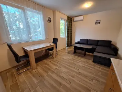 a living room with a couch and a table at Бобс апартаменти 2 in Kiten