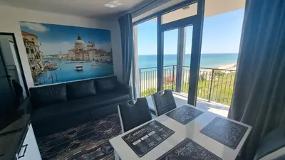 a living room with a couch and a large window at LUXE 1 Venezia Suite in Obzor
