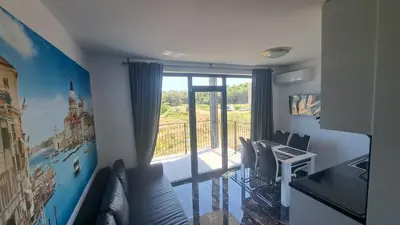 a room with a large window and a desk with chairs at LUXE 1 Venezia Suite in Obzor