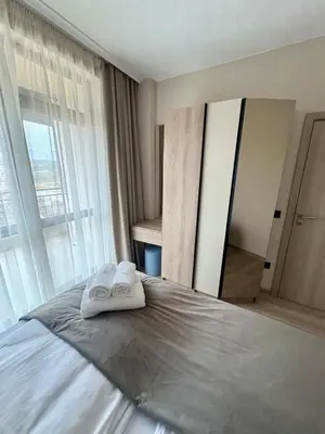 a bedroom with a bed with two towels on it at Sorrento Sole Mare Sveti Vlas in Sveti Vlas