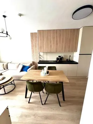 a living room with a wooden table and chairs at Sorrento Sole Mare Sveti Vlas in Sveti Vlas