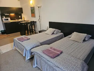 a room with two beds with towels on them at Студио за двама в Сарафово in Burgas City