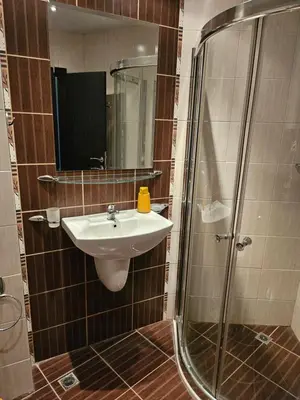 a bathroom with a sink and a shower at Студио за двама в Сарафово in Burgas City