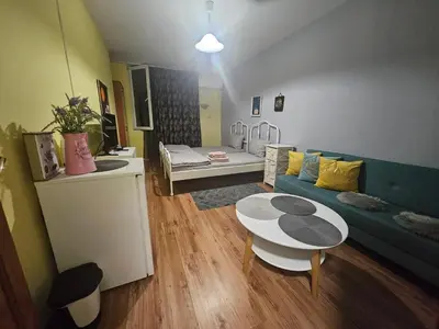 a living room with a couch and a table at Стая за двама в град Бургас in Burgas City